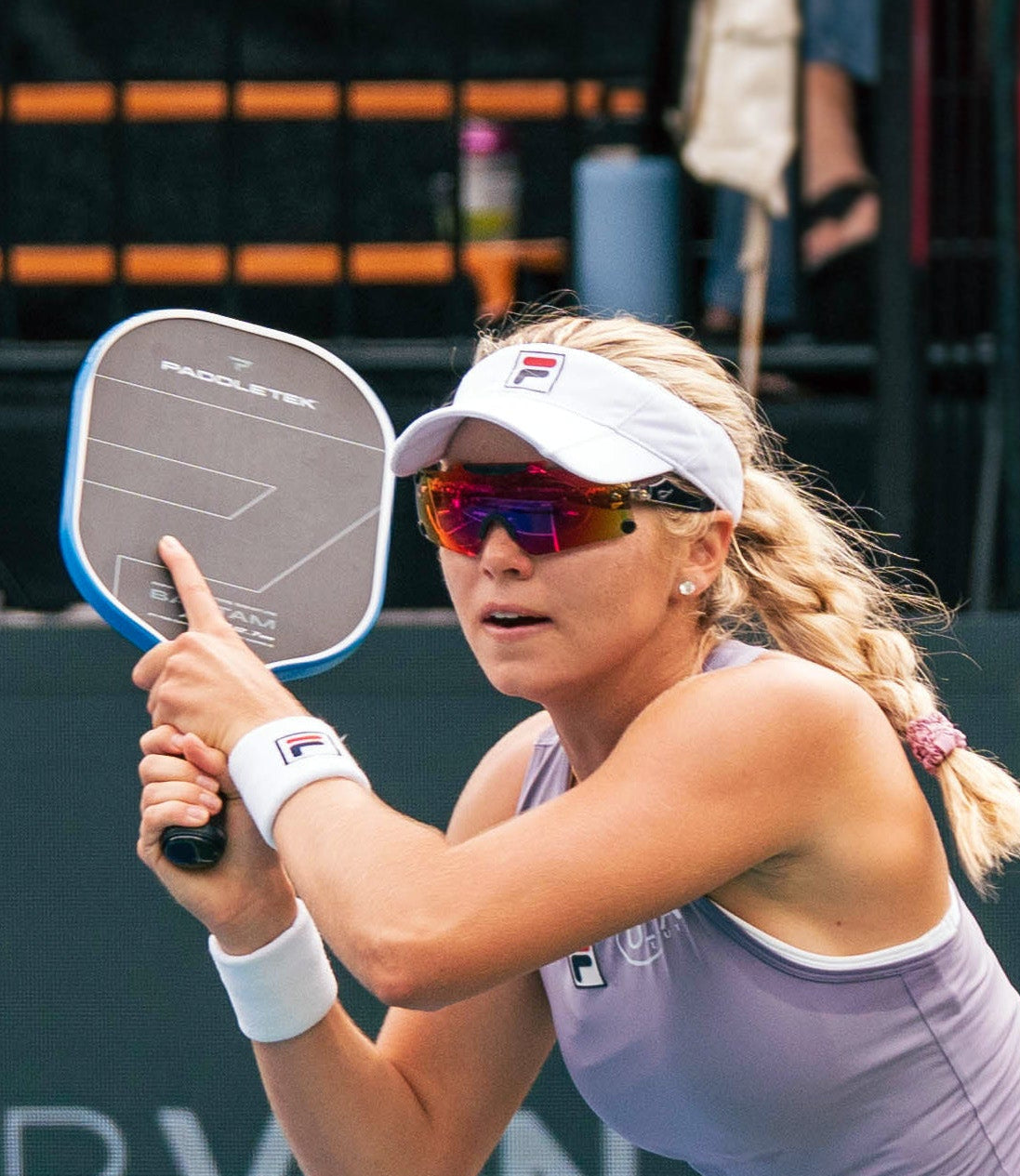Pickleball player in action on a court with Pilla glasses on