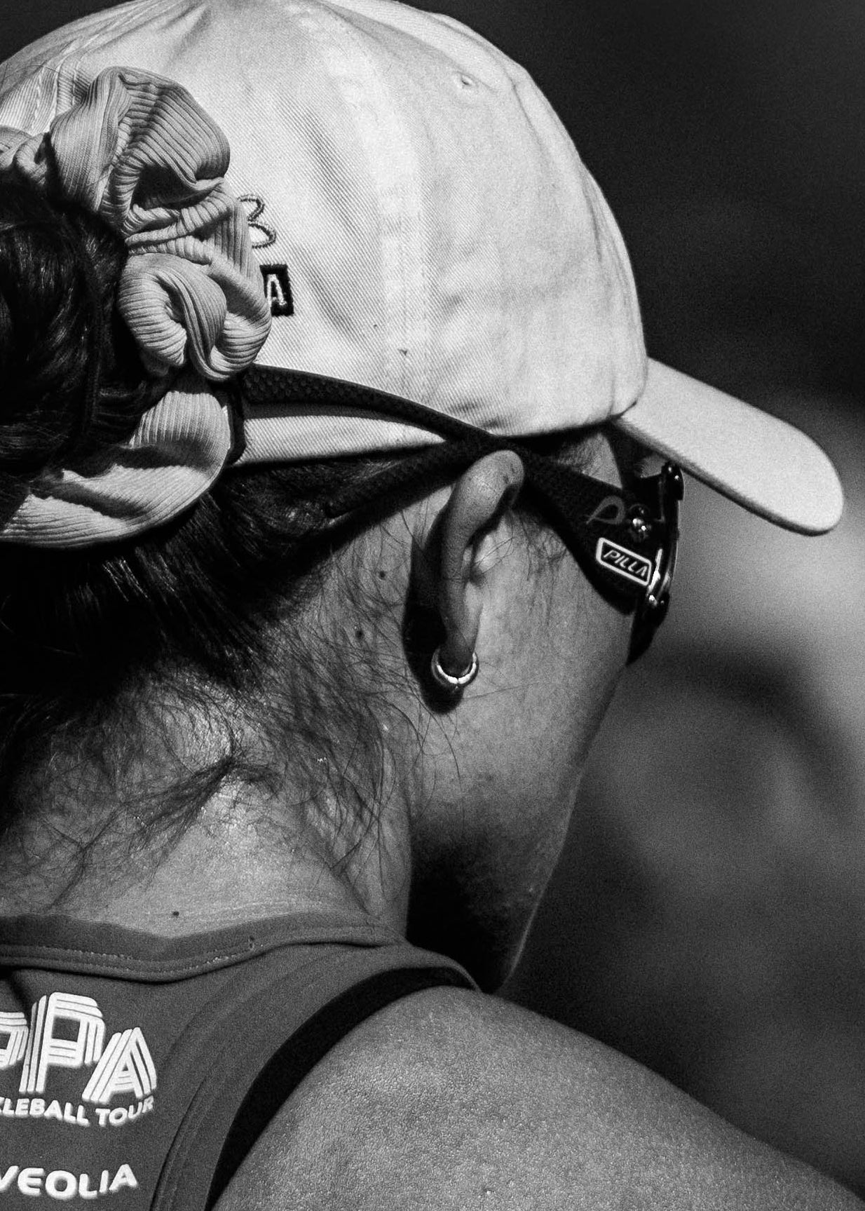 Person wearing a tank top with visible branding, looking away from the camera.