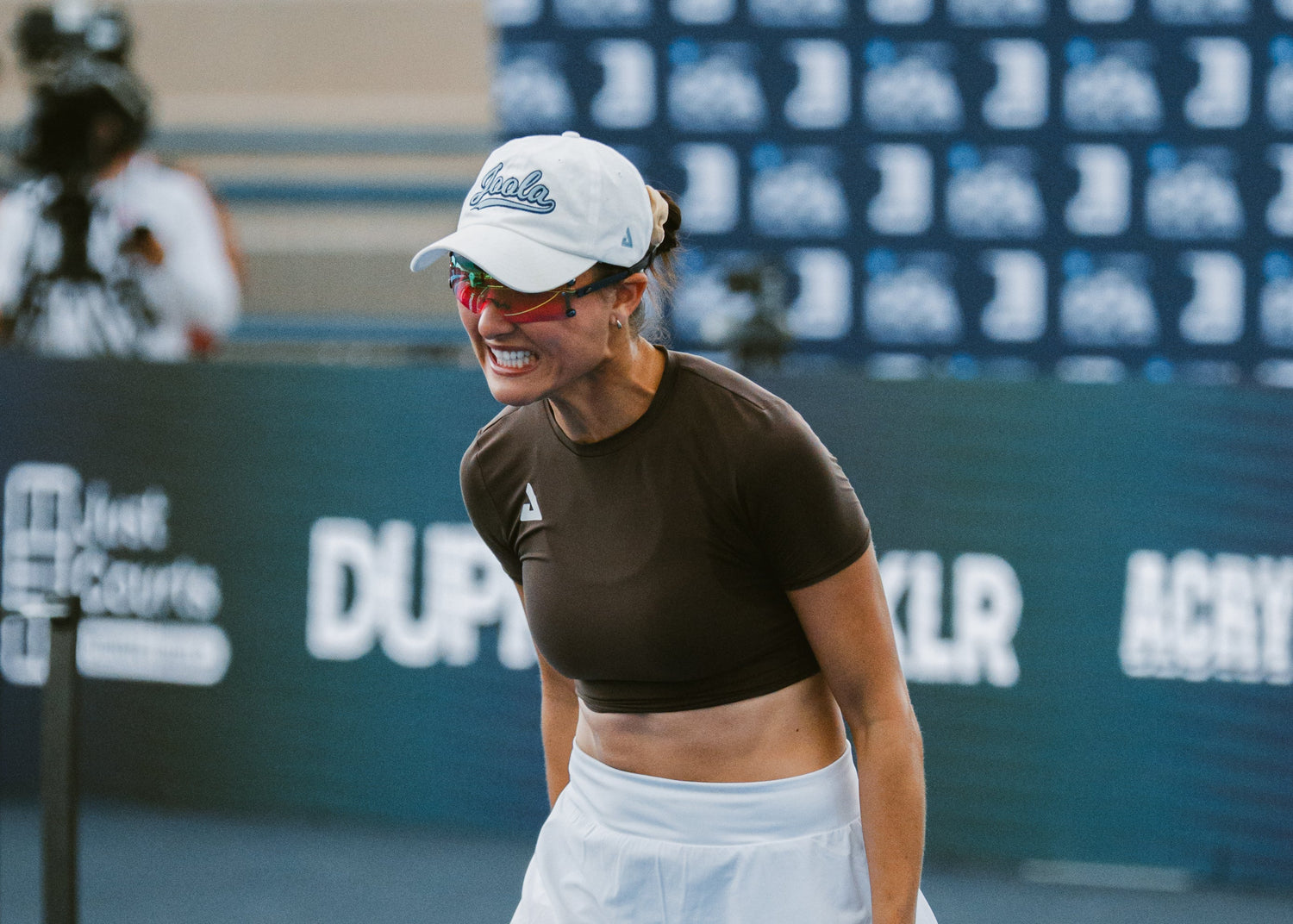 Pickleball Player on court wearing a cap and eyewear expressing a lot of emotion.